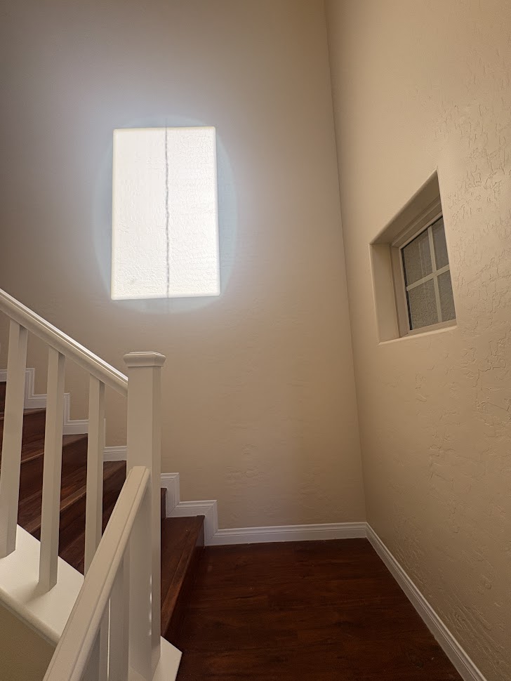 Before photo - Damaged stairwell walls with multiple holes in Las Vegas home